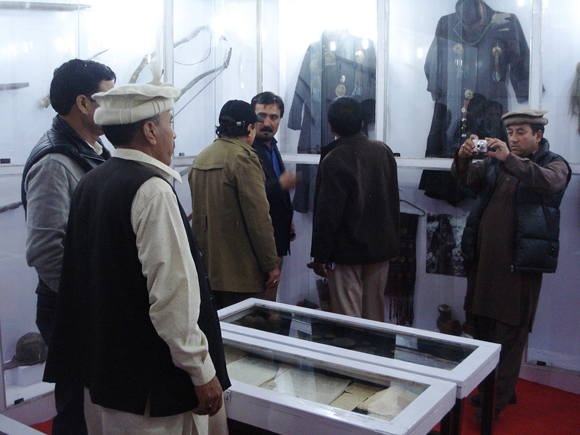 Workers deconstruct an image after the signing-in ceremony of the Chief Minister of India's newest state